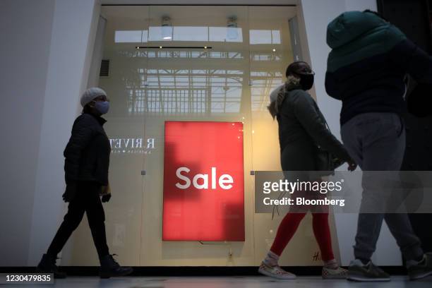 Shoppers walk past a "Sale" sign outside a store at the Easton Town Center Mall in Columbus, Ohio, U.S., on Thursday, Jan. 7, 2021. The U.S. Census...