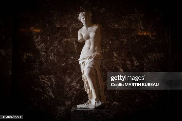 Picture taken on January 8, 2021 at the Louvre Museum in Paris shows the Venus of Milo sculpture in an empty hall, as the Museum remains closed due...