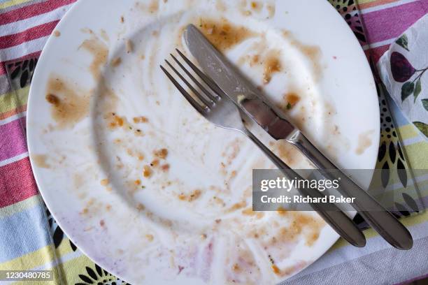 No turkey left on an empty plate after a family Christmas Day lunch in south London, on 25th December 2020 in London, England. Christmas lunch or...