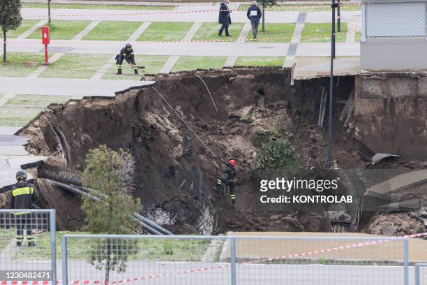 The Italian fire fighters check the enourmous chasm, 2500 meter square for 15 meter deep, caused by explosion of hospital oxigen underground pipeline...