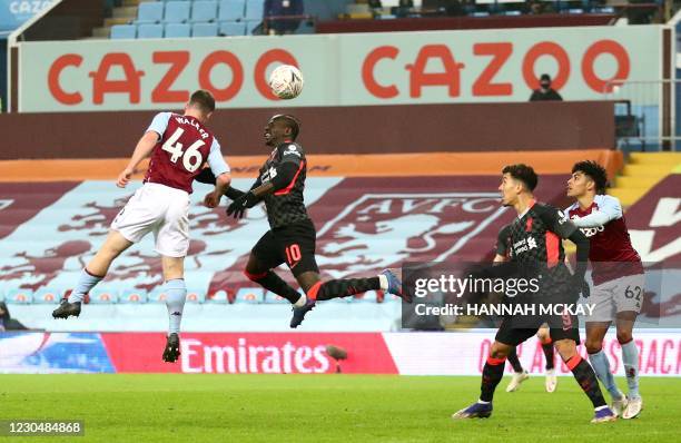 Liverpool's Senegalese striker Sadio Mane beats Aston Villa's English defender Jake Walker to scores his team's third goal during the English FA Cup...