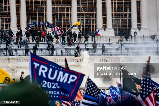 Supporters of US President Donald Trump clash with the US Capitol police during a riot at the US Capitol on January 6 in Washington, DC. - Donald...