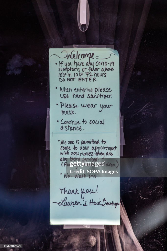 A sign explaining the requirements for entry hangs on the...