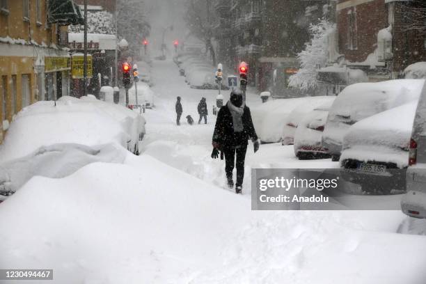 Man walks on the snow covered road during heavy snowfall in Madrid, Spain on January 09, 2021. Spain is on red alert for a second day due to storm...