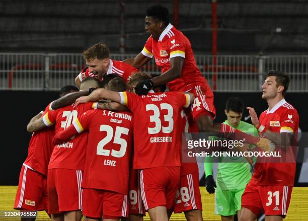 Union Berlin's players celebrate after Union Berlin's German midfielder Robert Andrich scored during the German first division Bundesliga football...