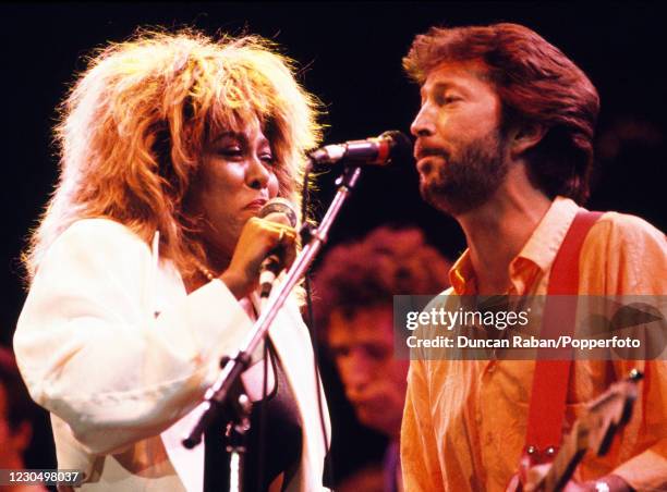 American singer Tina Turner and English musician Eric Clapton performing on stage together during the Prince's Trust 10th Anniversary Rock Gala at...