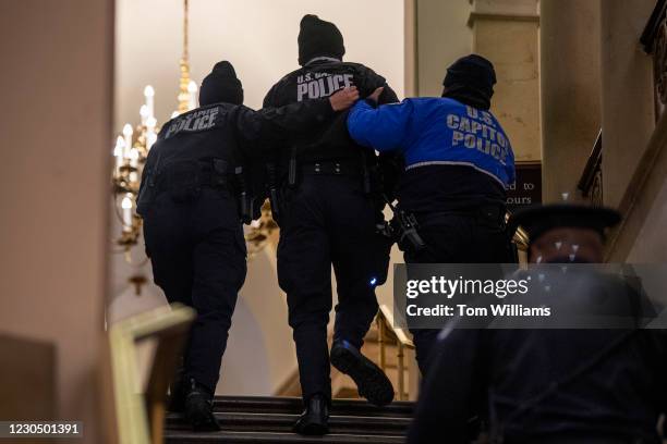 Capitol Police officer receives medical treatment after clashes with rioters who disrupted the joint session of Congress to certify the Electoral...