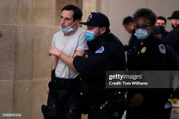 Capitol Police officer receives medical treatment after clashes with rioters who disrupted the joint session of Congress to certify the Electoral...