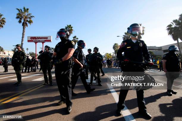 Police form a skirmish line to block counter-protesters from clashing with demonstrators holding a "Patriot March" demonstration in support of US...