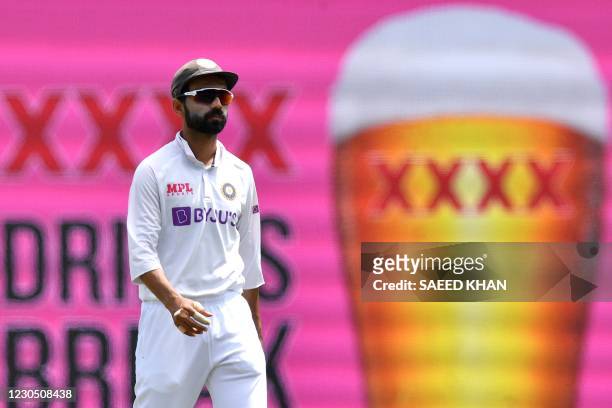 India's captain Ajinkya Rahane walks towards his fielding position during day four of the third cricket Test match between Australia and India at the...