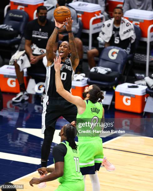 DeMar DeRozan of the San Antonio Spurs shoots the ball over Ricky Rubio of the Minnesota Timberwolves during the third quarter at Target Center on...