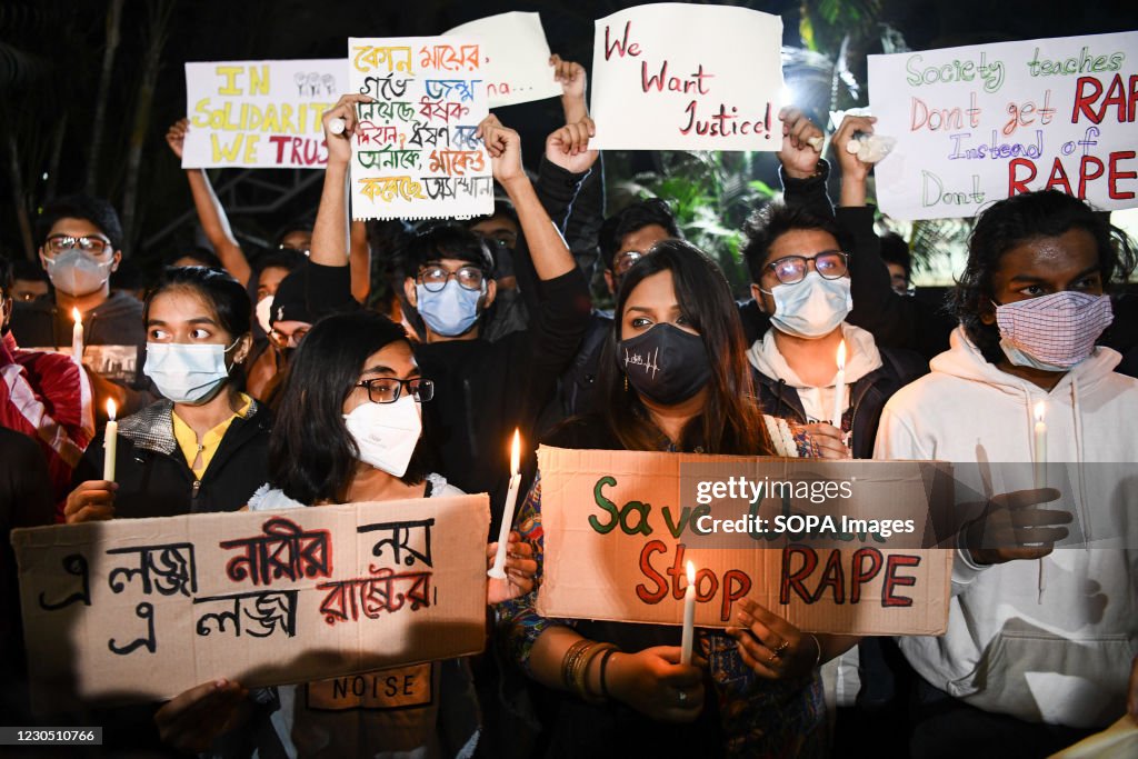 Female activists and students wearing face masks hold...