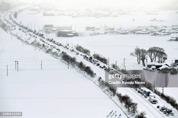 Photo taken from a Kyodo News helicopter shows vehicles stranded in the snow on the Hokuriku Expressway in Fukui Prefecture, central Japan, on Jan....