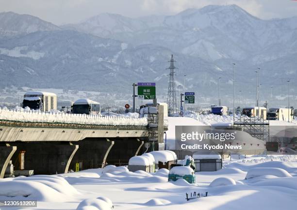 Vehicles are stranded in the snow on the Tokai Hokuriku Expressway in Toyama Prefecture, central Japan, on Jan. 10, 2021. Heavy snowfall continued...