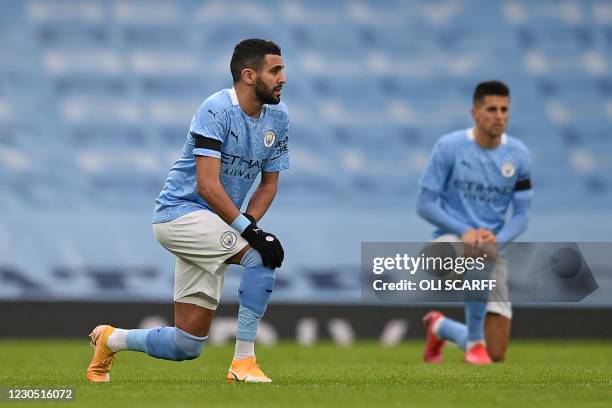 Manchester City's Algerian midfielder Riyad Mahrez 'takes a knee' in support of anti-racism campaigns ahead during the English FA Cup third round...