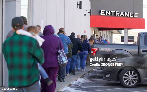 People line up to buy guns and ammunition at the Ready Gunner gun store on January 10, 2021 in Orem, Utah. - Ammunition and guns sales have spiked in...