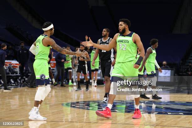 Angelo Russell of the Minnesota Timberwolves celebrates with Karl-Anthony Towns of the Minnesota Timberwolves during the game against the San Antonio...