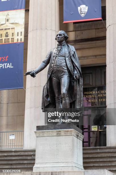 Bronze statue of the first President of the United States of America, George Washington, overlooks Wall Street and the New York Stock Exchange NYSE...