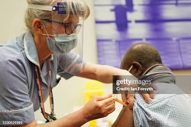 Mr Nana Kwabena Edusei, aged 81 from Heaton, receives his vaccination from Staff Nurse Caroline McGuinness at the International Centre for Life on...