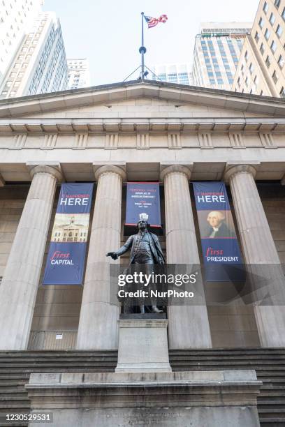 Bronze statue of the first President of the United States of America, George Washington, overlooks Wall Street and the New York Stock Exchange NYSE...