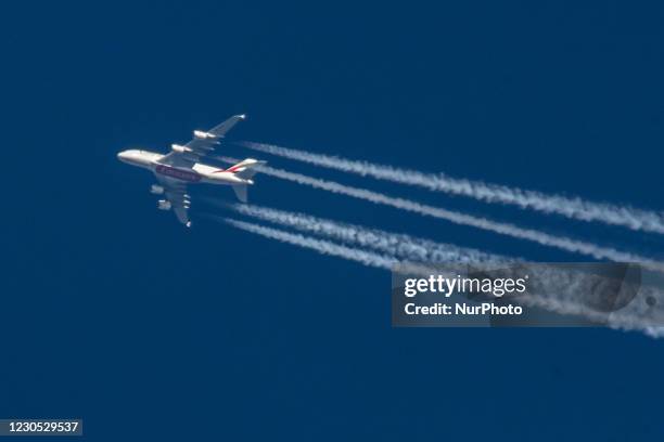 Emirates Airbus A380 aircraft as seen flying in the blue sky over the Netherlands in Europe the route from Dubai DXB, UAE to Manchester MAN in the...