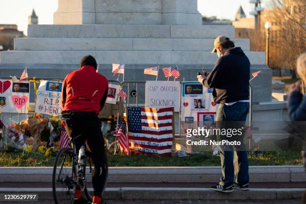 Flowers and candles are seen at a memorial for the dead people at the US Capitol after US President Donald Trump's supporters stormed the building,...