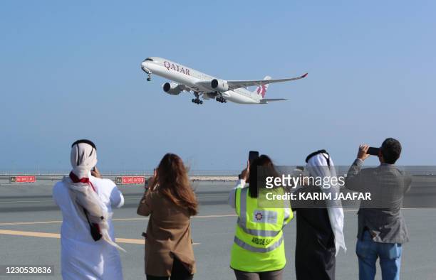Qatar Airways Airbus A350 airplane takes off from Hamad International Airport near the Qatari capital Doha, on the first commercial flight to Saudi...
