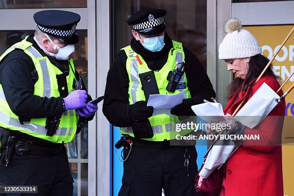 Ppe In Police Police officers wearing PPE face masks speak to a protester outside ...