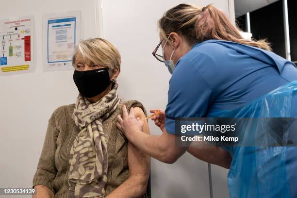 Rita Passey receives her injection of the Oxford AstraZeneca vaccine at the new Millennium Point NHS Covid-19 Vaccination Centre on 11th January 2021...