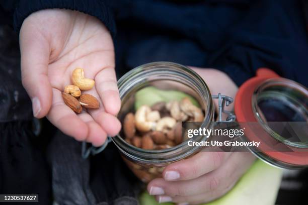 Bonn, Germany In this photo illustration nuts and almonds are in a child hand on January 09, 2021 in Bonn, Germany.