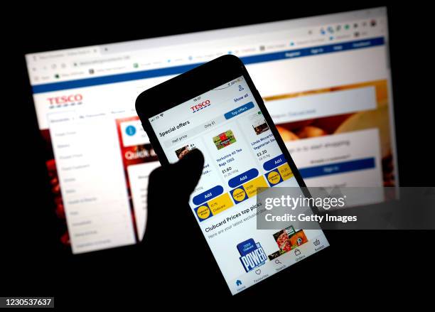 In this photo illustration, the grocery shopping app for Tesco is seen on a mobile phone on January 11, 2021 in London, United Kingdom.