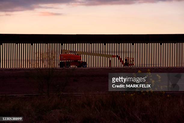 Mechanical lift sits next to a section of newly constructed border wall in Hidalgo, Texas on January 11, 2021. - Chad Wolf, the acting secretary of...