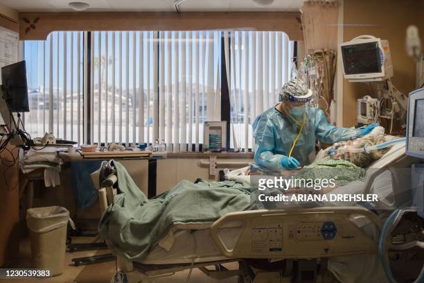 Registered Nurse tends to a Covid-19 patient in the Intensive Care Unit at Providence St. Mary Medical Center in Apple Valley, California on January...