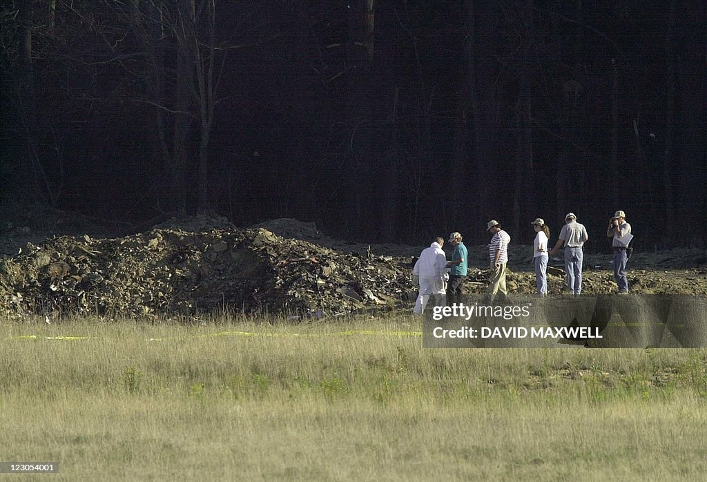 Officials examine the crater 11 Septembe