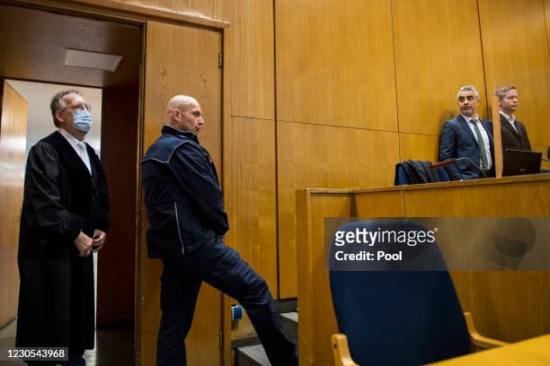 Main defendant Stephan Ernst stands next to his lawyer Mustafa Kaplan as presiding judge Thomas Sagebiel arrives at the courtroom prior to another...