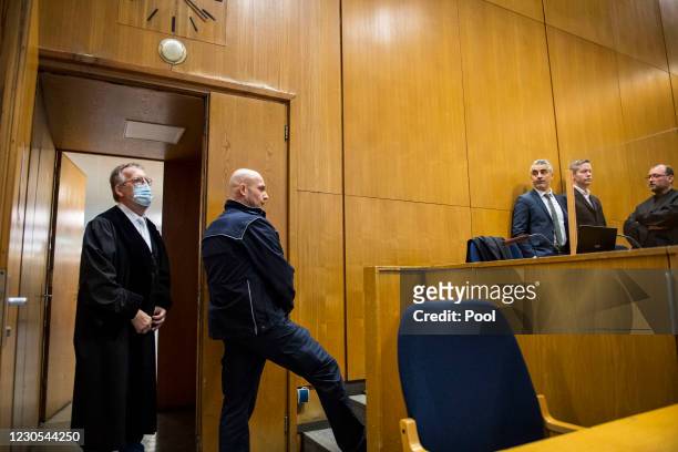 Main defendant Stephan Ernst stands between his lawyers Mustafa Kaplan and Joerg Hardies as presiding judge Thomas Sagebiel arrives at the courtroom...