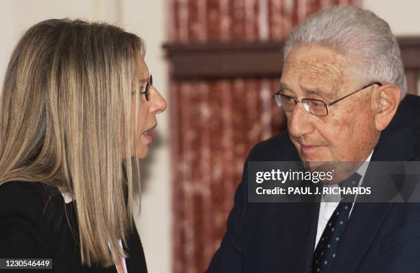 Entertainer Barbra Streisand and former US Secretary of State Henry Kissinger talk while attending a official luncheon at the US Department of State...