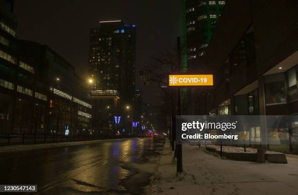 Sign reading "Covid-19" on Rene Levesque Boulevard during curfew hours in downtown Montreal, Quebec, Canada, on Monday, Jan. 11, 2021. Quebec has...