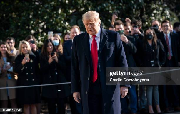 President Donald Trump turns to reporters as he exits the White House to walk toward Marine One on the South Lawn on January 12, 2021 in Washington,...