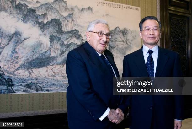 Former US Secretary of State Henry Kissinger shakes hands with Chinese Premier Wen Jiabao at Zhongnanhai in Beijing on January 13, 2009 as part of a...