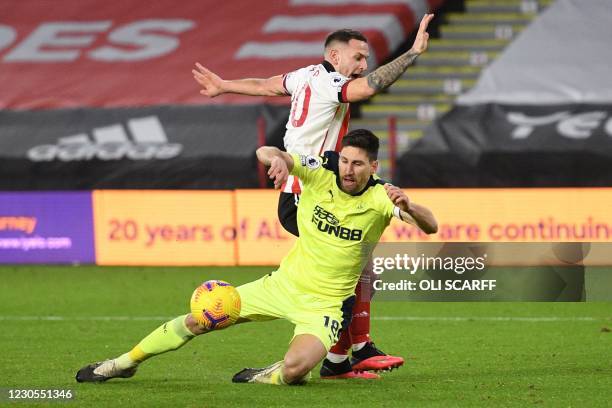 Newcastle United's Argentinian defender Federico Fernandez clashes with Sheffield United's English striker Billy Sharp during the English Premier...
