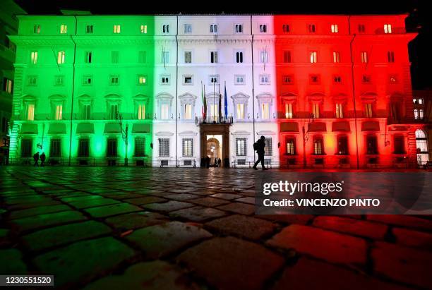 View taken on January 12, 2021 in Rome shows the Palazzo Chigi, the seat of the Italian government, lit with the colors of the Italian flag as...