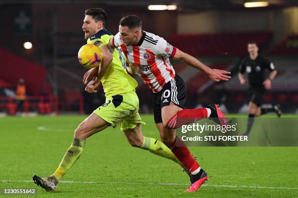 Newcastle United's Argentinian defender Federico Fernandez handballs the ball to concede a penalty as he vies with Sheffield United's English striker...