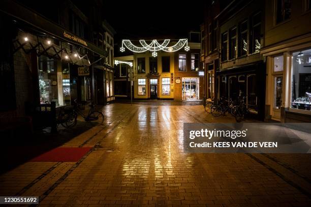 Picture taken on January 12, 2021 shows a deserted street of Grote Kromme Elleboog in the center of Groningen. - The Dutch government is...