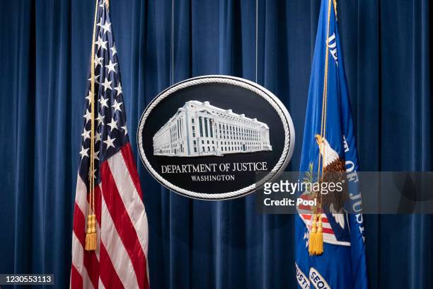 Sign for the Department of Justice is seen before Steven D'Antuono, FBI Washington field office Assistant Director in Charge and Michael Sherwin,...