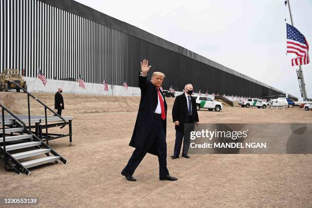 President Donald Trump waves after speaking and touring a section of the border wall in Alamo, Texas on January 12, 2021.