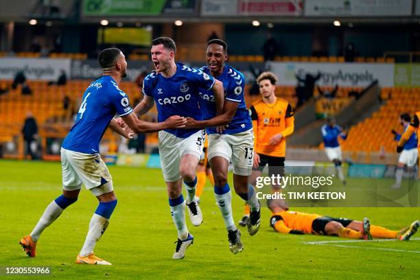 Everton's English defender Michael Keane celebrates scoring his team's second goal with Everton's English defender Mason Holgate and Everton's...