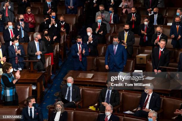 Sen. Ted Cruz, R-Texas, center with purple tie, and Rep. Paul Gosar, R-Ariz., to the right, are applauded by Republican colleagues for objecting to...