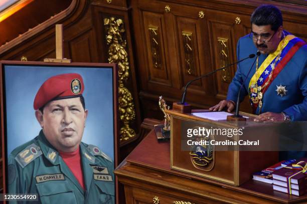 President of Venezuela Nicolas Maduro speaks next to an image of late former President of Venezuela Hugo Chavez during the State of The Nation Report...