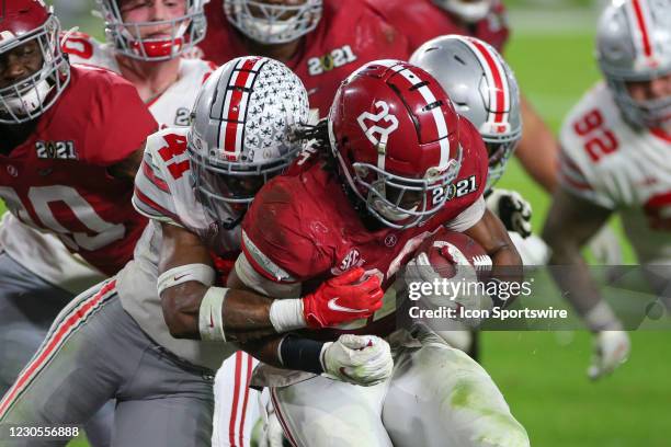 Alabama Crimson Tide running back Najee Harris is tackled by Ohio State Buckeyes safety Josh Proctor in the end zone for a touchdown during the CFP...